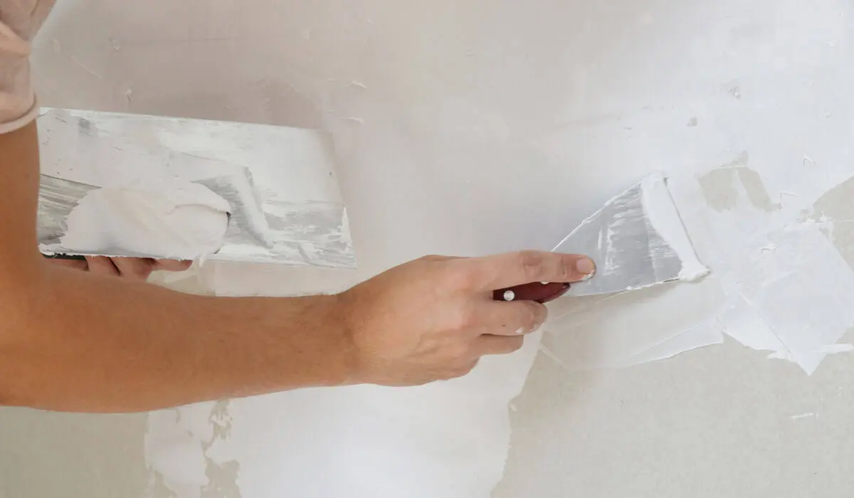 Process of plastering wall with putty-knife. Fixing w