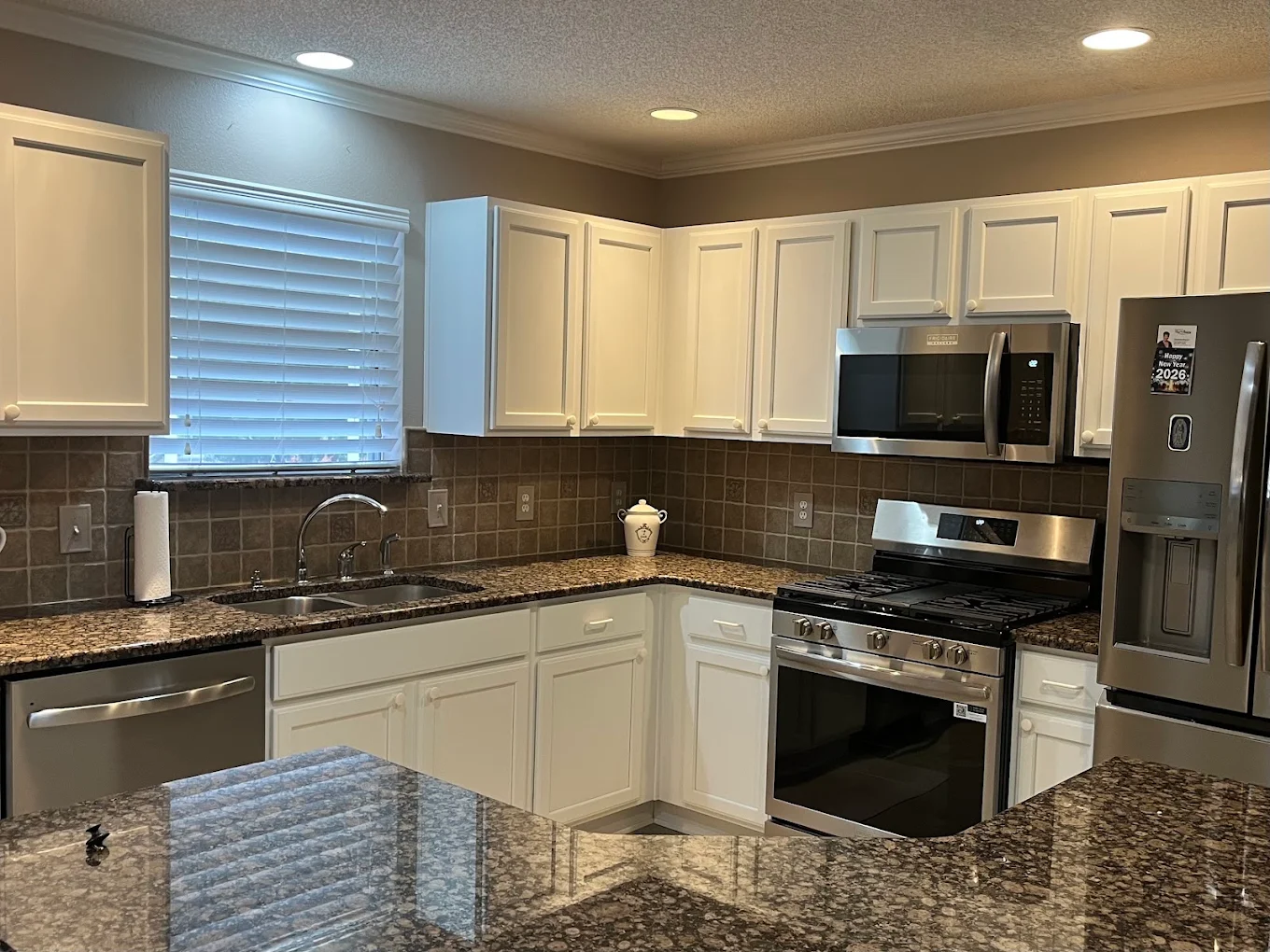 Cabinet refinishing 8 Refinished white kitchen cabinets in an Inverness, FL home by Make It Happen Painting